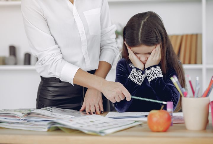 Tutor with pupil. Little girl studying. Private lesson.